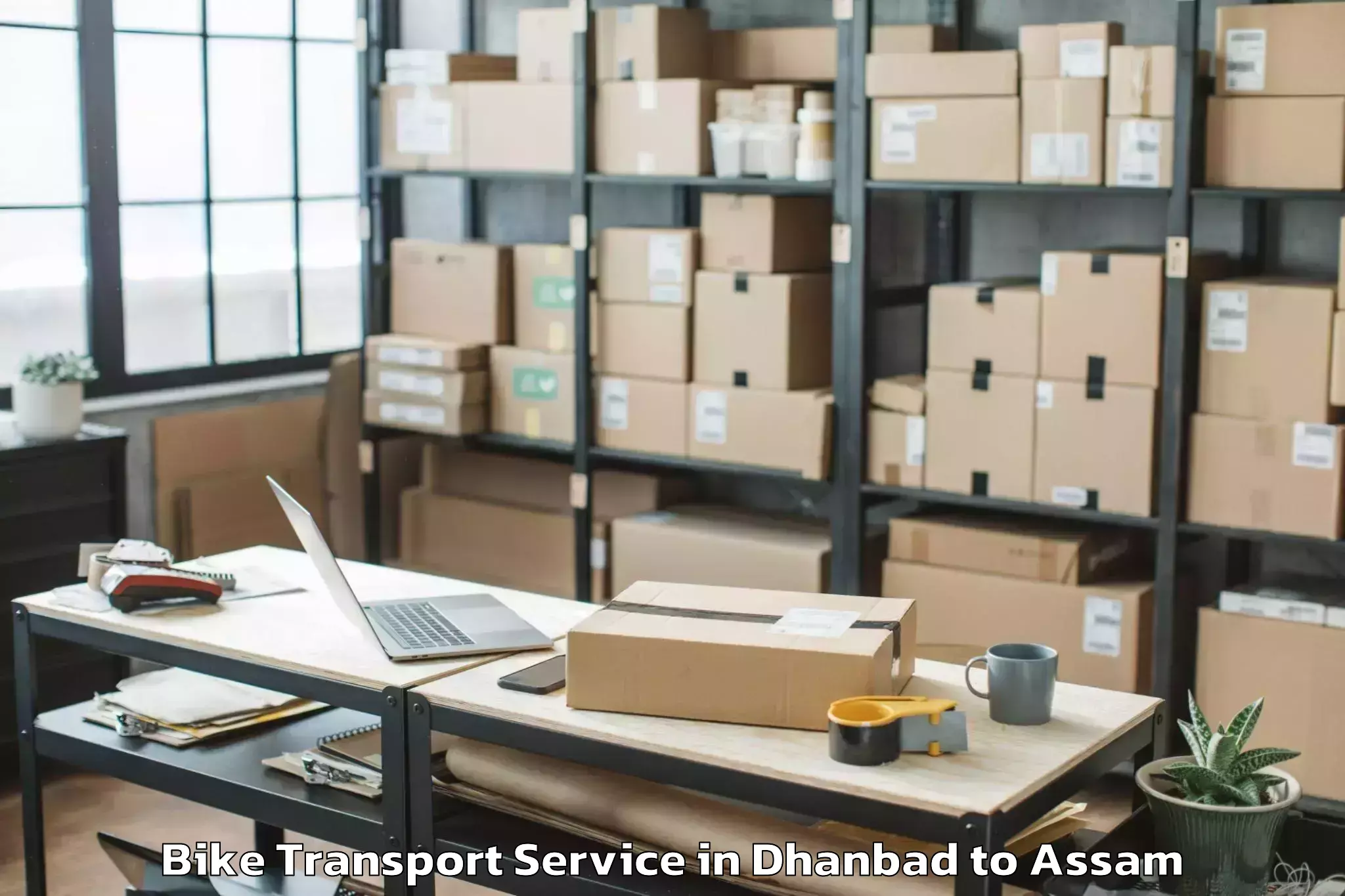 Top Dhanbad to Chaparmukh Bike Transport Available